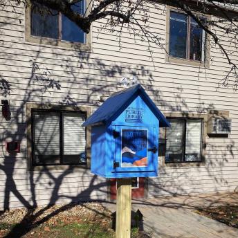 Little Free Library stands in front of a leasing office